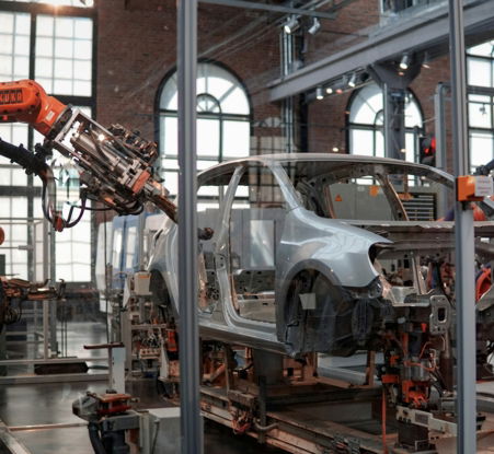 gray-vehicle-being-fixed-inside-factory-using-robot-machines.jpg gray vehicle being fixed inside factory using robot machines